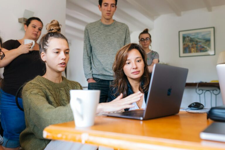A diverse group of adults collaborating in a cozy indoor office space.